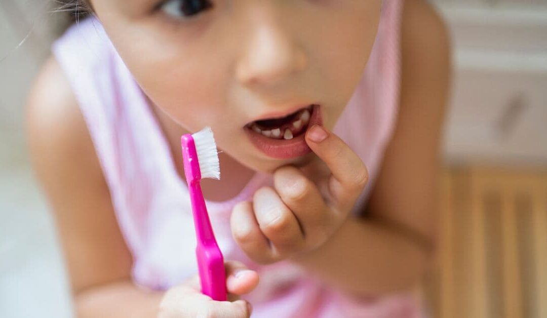 When to go to the dentist to remove a rocking baby tooth?